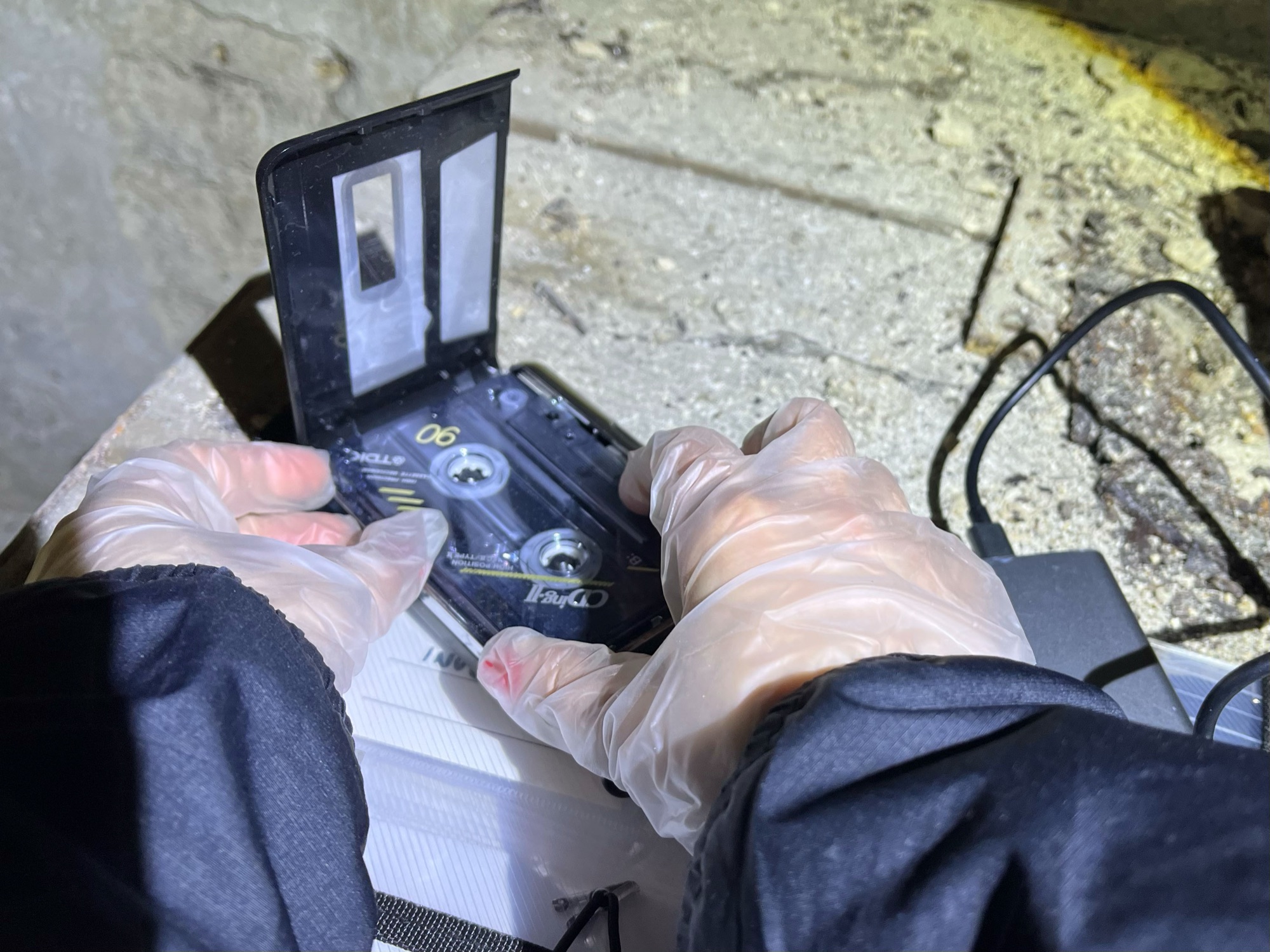 Opening a cassette tape found on site