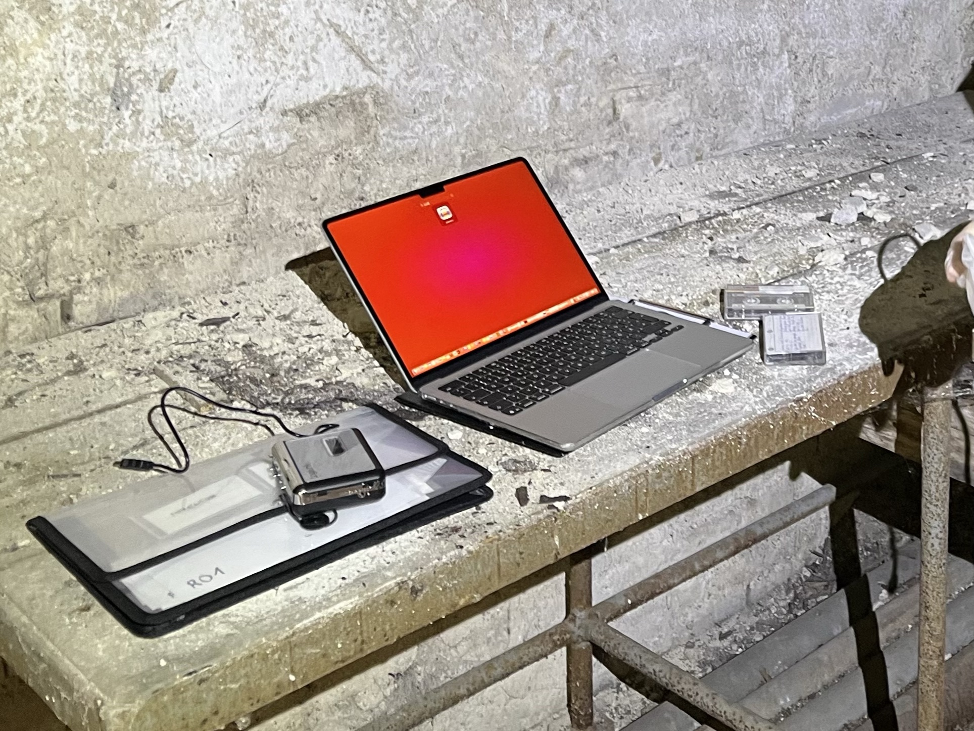 Laptop and cassette player set up on a dusty table for digitizing